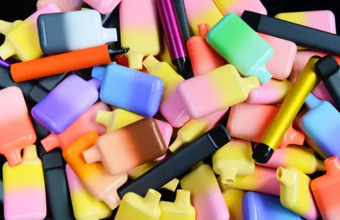 Peter Dazeley/ Getty Creative A pile of colourful vapes. 