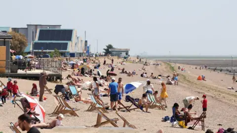 PA Media Wide angle shot of people enjoying the sunshine on Jubilee Beach in Southend