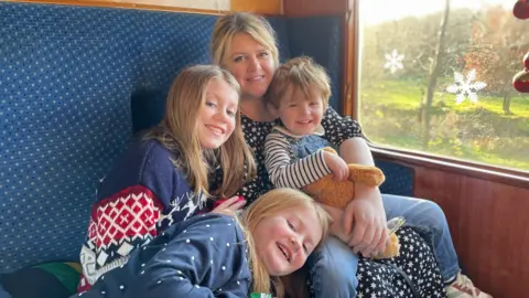 Kate Dyson A picture of Kate Dyson and her three children.