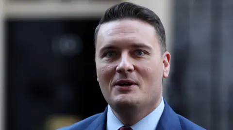 EPA/Shutterstock Health Secretary Wes Streeting faces the camera, wearing a blue suit and light blue shirt
