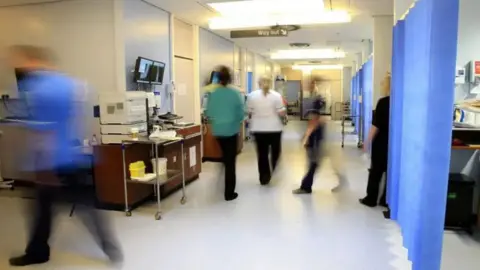 PA Media Medical staff in a hospital ward 